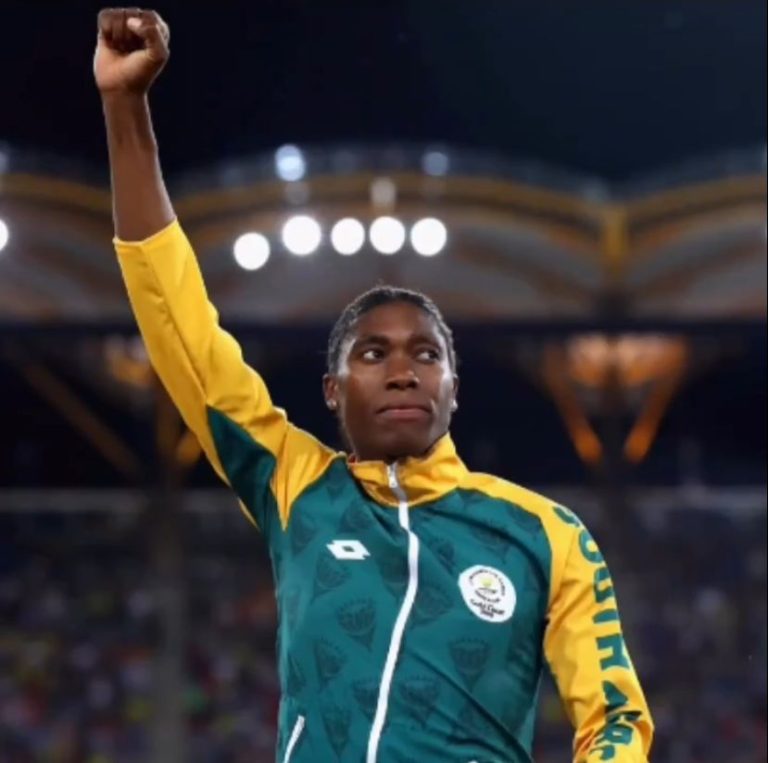 Caster Semenya sprints across the finish line with unwavering determination etched on her face, symbolizing her unrelenting passion for the sport.