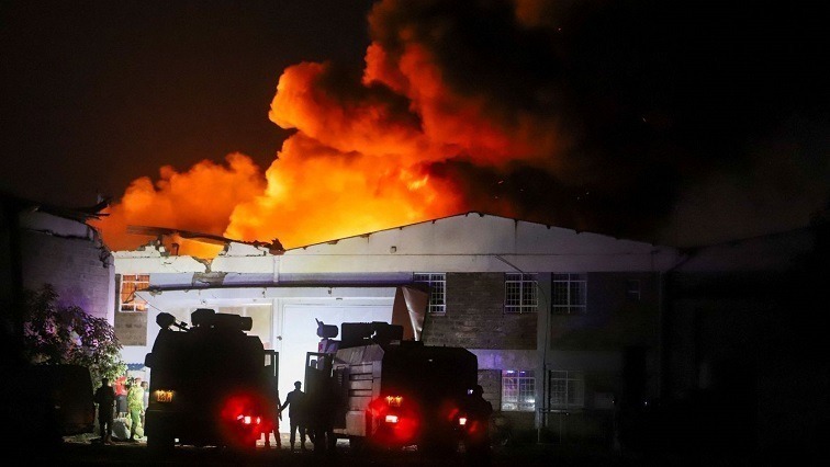 Firefighters struggle to contain the inferno as it spreads to neighboring buildings