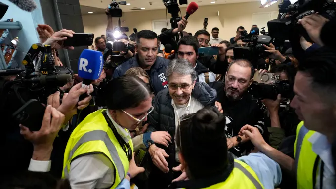 Fabio Ochoa, center, is swarmed by media upon his arrival at El Dorado airport in Bogota, Colombia, December 23, 2024.