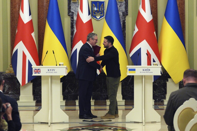 British Prime Minister Keir Starmer and Ukrainian President Volodymyr Zelensky shake hands after signing a security and trade agreement at Mariinsksyi Palace in Kyiv. Image: AP.