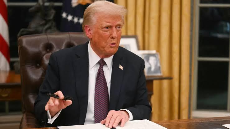 Donald Trump signing papers