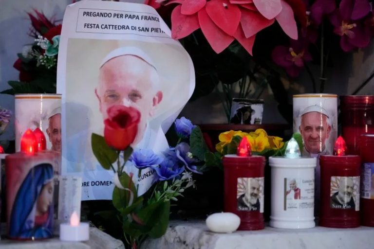 Candles and pictures of Pope Francis seen outside the Agostino Gemelli Polyclinic in Rome, on Sunday, where the Pontiff is hospitalised since Feb. 14. Image: AP.