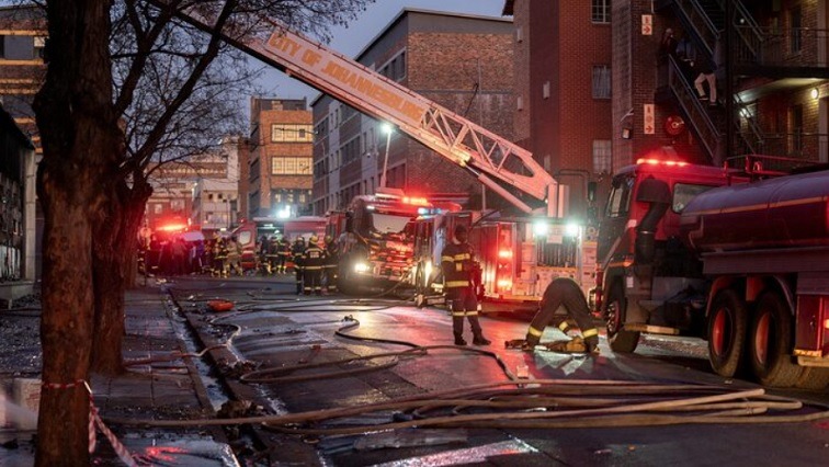 Firefighters respond to the aftermath of the Usindiso building fire in Johannesburg, as investigations into hijacked buildings and illegal landlords continue. Image credit: Reuters