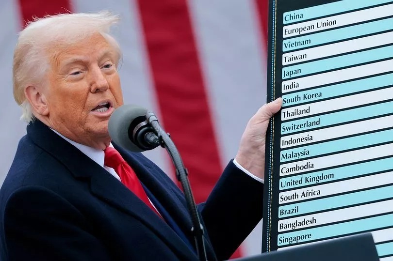 US President Donald Trump holds a reciprocal tariffs poster during a tariff announcement in the Rose Garden of the White House in Washington, DC, US, on Wednesday, 2 April, 2025. Getty Images