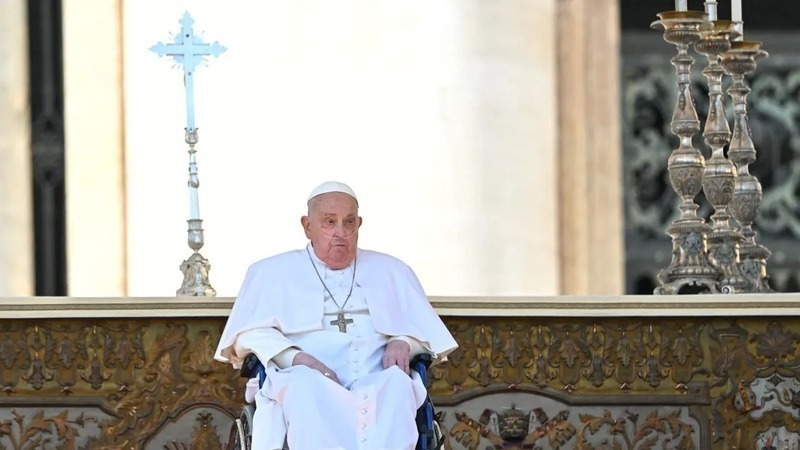 Pope Francis, seen wearing an oxygen breathing apparatus, looks on during a surprise appearance at the end of a mass for the sick and healthcare workers on St. Peter's square in The Vatican, on April 6. Image credit: AFP.
