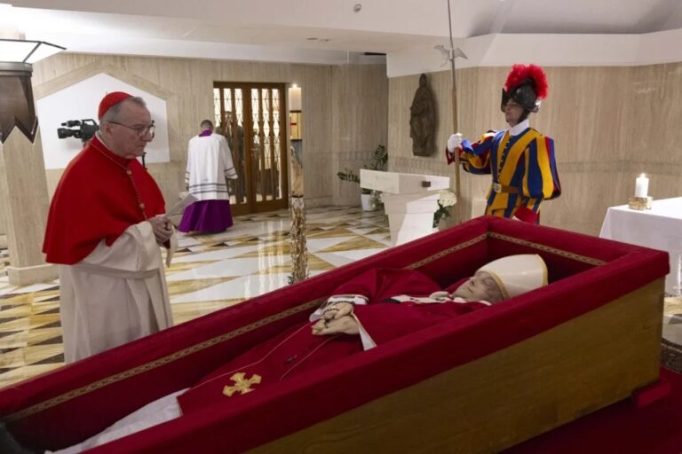 The body of Pope Francis lies in his private chapel at the Vatican on Monday for church officials to say their goodbyes. At left, Vatican Secretary of State Cardinal Pietro Parolin prays. Photo: Vatican Media
