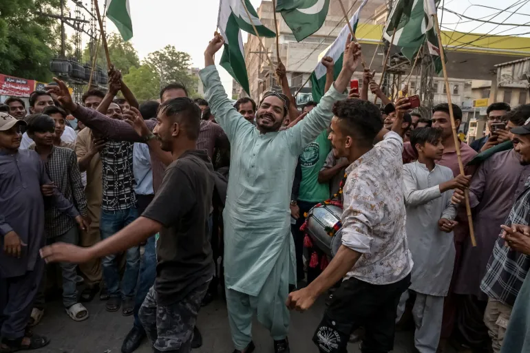 Pakistan people celebrate after the ceasefire between Pakistan and India, in Hyderabad, Sindh province, on May 10, 2025 [Akram Shahid/AFP]