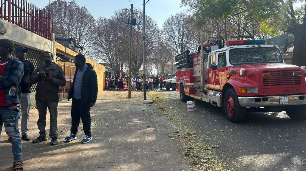Forensic investigators examine the charred remains of a bedroom where four children tragically lost their lives during a fire in a Mayfair residence. Authorities are probing the scene for potential accelerants and structural anomalies as part of the ongoing investigation. Source image : Picture: Jabulile Mbatha/EWN.