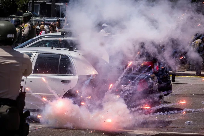 A firework explodes after being thrown at police. Barbara Davidson/Reuters