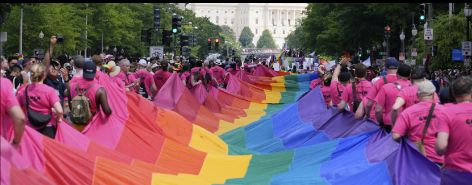 On June 7, 2025, participants in the WorldPride parade proudly display a massive Pride flag in front of the U.S. Capitol. (AP Photo/Mark Schiefelbein)