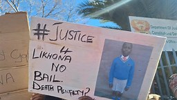 Banners calling for those involved in Likhona Fose's murder to be brought to justice. Image: eNCA/Hloni Mtimkulu.