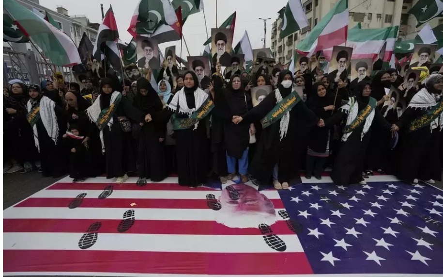 Shiite Muslims stand over a representation of the US flag during a rally to condemn Israeli strikes on Iran, in Karachi, Pakistan, Sunday, June 22, 2025. Image: AP/Fareed Khan.