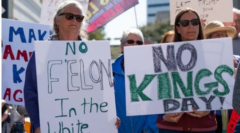 Protesters display “No King” banners during demonstrations coinciding with President Trump’s 79th birthday and the U.S. Army’s 250th anniversary. [Samantha Neely/USA Today]