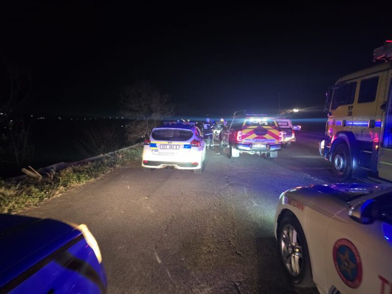 A minibus taxi lies overturned on the side of the road after a horrific accident on the N3 highway near the Mariannhill Toll Plaza, resulting in five fatalities, including two policemen.