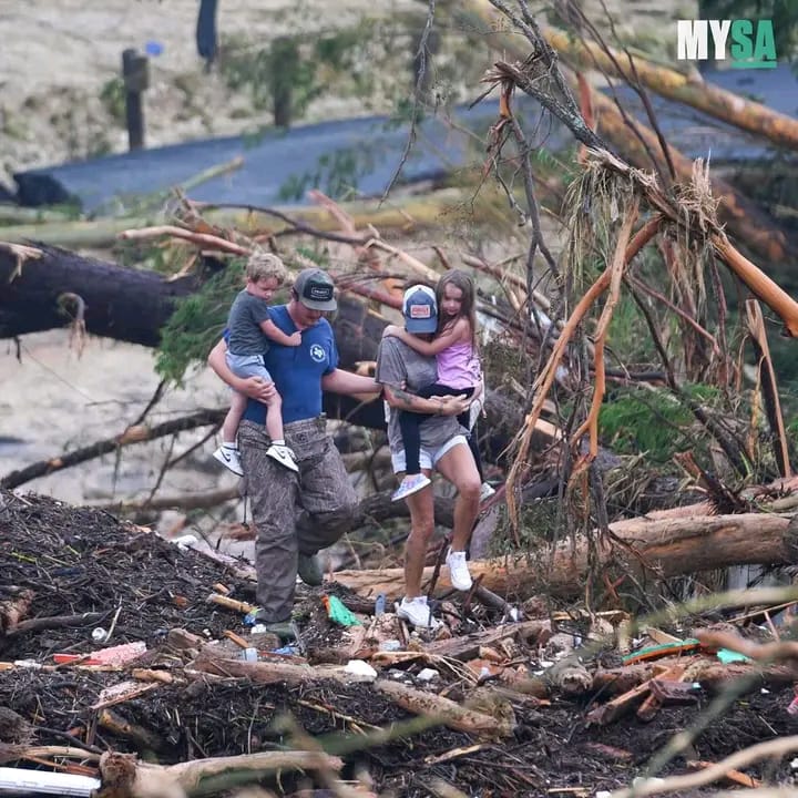 People stepping over debris after a flash flood tore through the area, Guadalupe River.