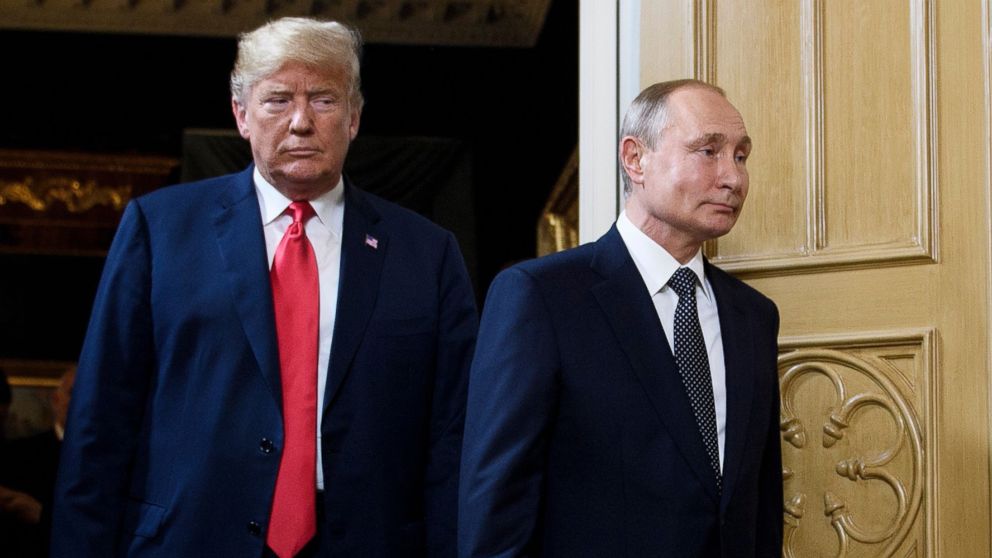 A photograph of Donald Trump and Vladimir Putin, by Brendan Smialowski for AFP/Getty Images, capturing the US President's reaction during a meeting or press conference, potentially related to the tensions with Vladimir Putin over Ukraine.
