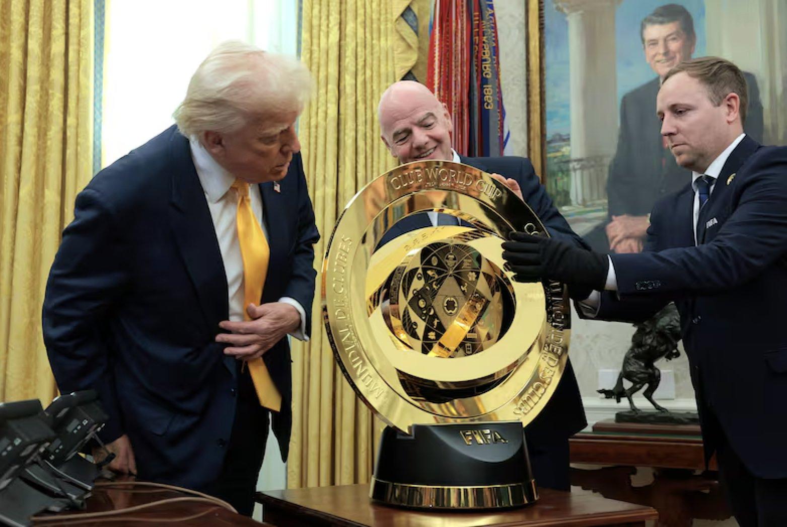 From left is U.S president Donald Trump, and FIFA president Gianni Infantino, and a FIFA official handing a Club World Cup 2025 at the Oval Office. Image: TouchlineX on X