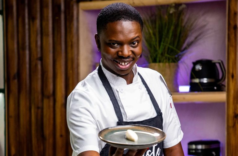Chef Lucky Masinya proudly presents one of his creations during his time on "The Taste Master SA." His culinary journey is an inspiring tale of perseverance and passion.
