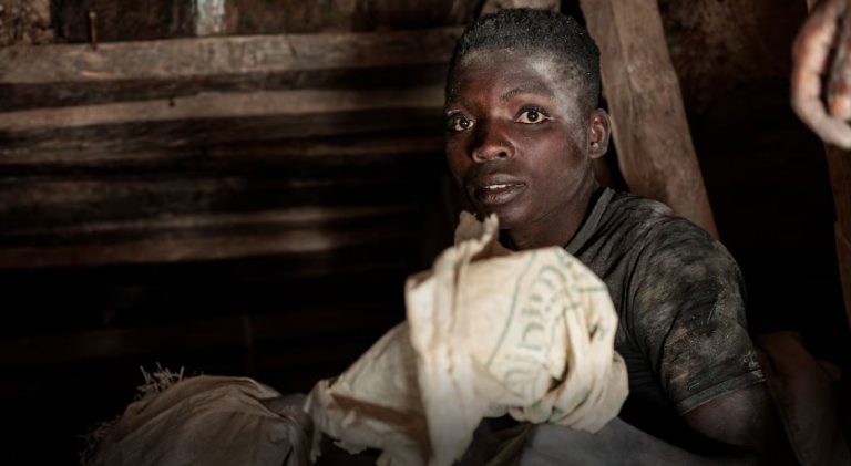 Credit Image: Reuters A laborer, face streaked with white dust, transports coltan ore in a subterranean mine near Rubaya, DRC.