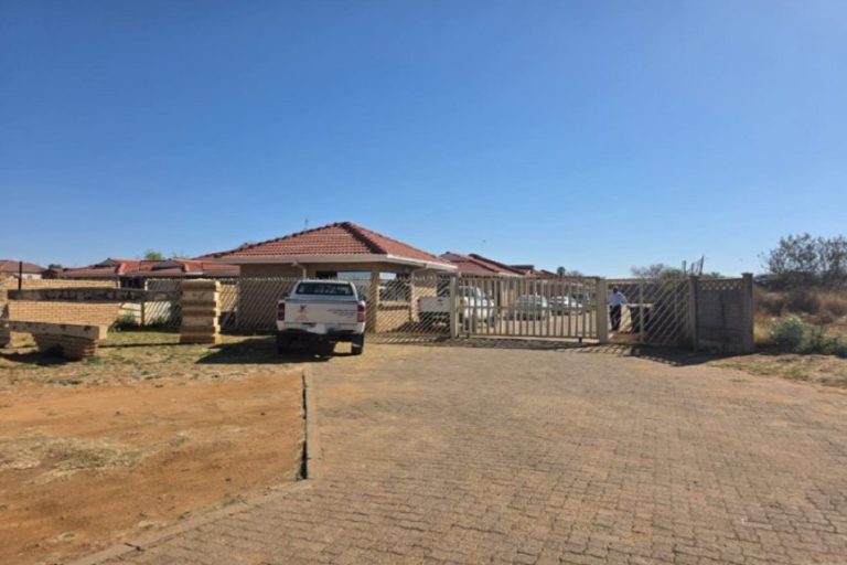 Mahikeng children’s shelter appears secured and occupied, with a locked gate, parked vehicles, and no visible presence of children.
