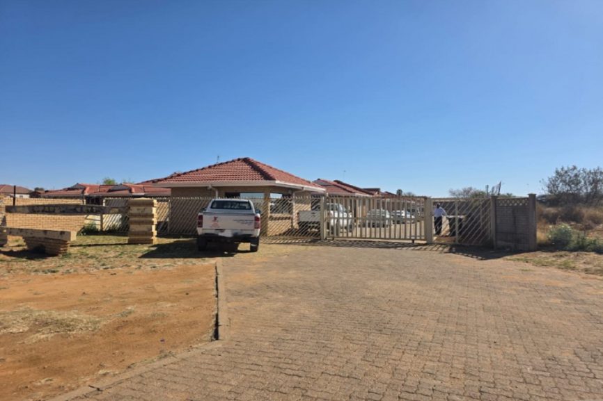 Mahikeng children’s shelter appears secured and occupied, with a locked gate, parked vehicles, and no visible presence of children.