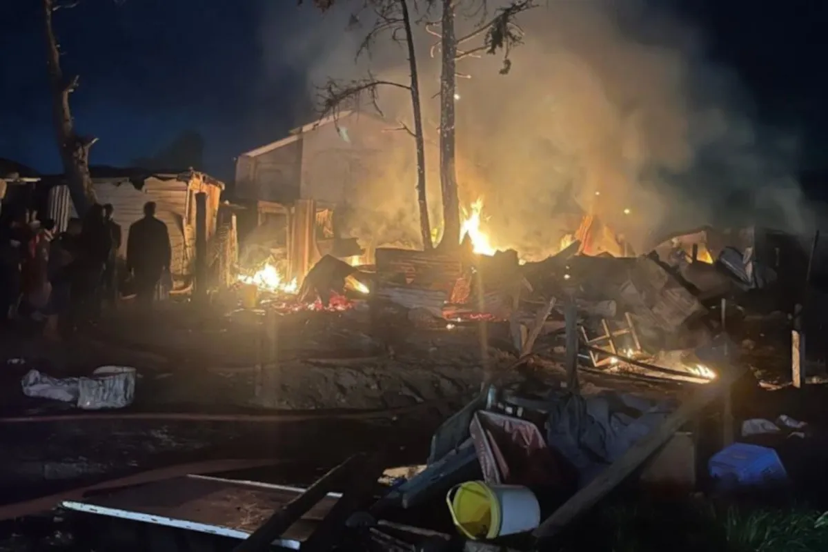 Westlake informal settlement fire destroys several shacks at night, leaving families displaced as flames and smoke rise into the sky.