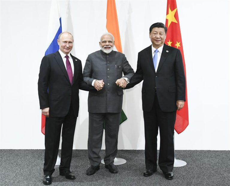 India PM locks hands with President Xi and Putin