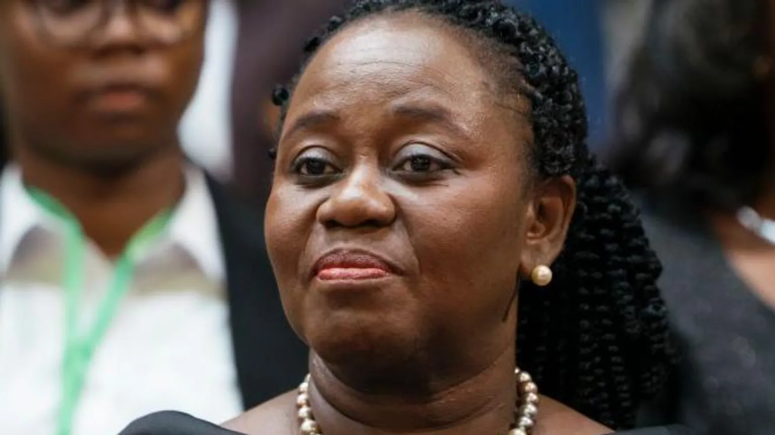 Gertrude Torkornoo, Ghana’s Top Judge, Removed from Her Post 1 Chief Justice Gertrude Torkornoo with two women, one wearing gloves and a green name tag around her neck.