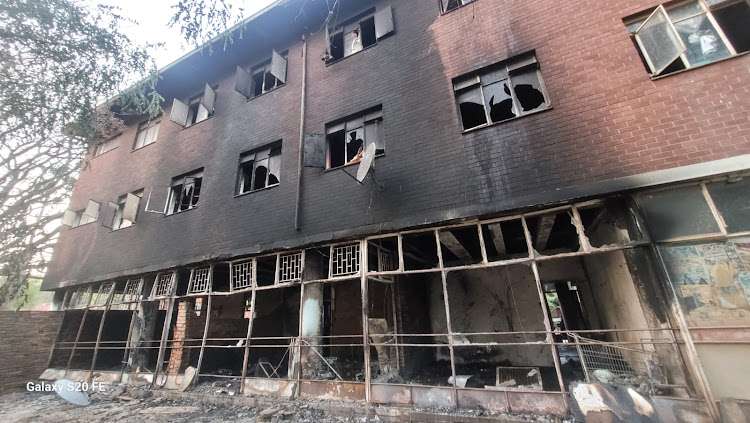 2 Deaths in Fire scene shows burned abandoned building in Sunnyside, Tshwane, with charred walls and broken windows after blaze.
