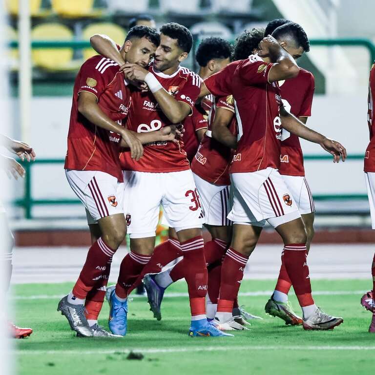 Al Ahly squad celebrating a goal against Ennpi.