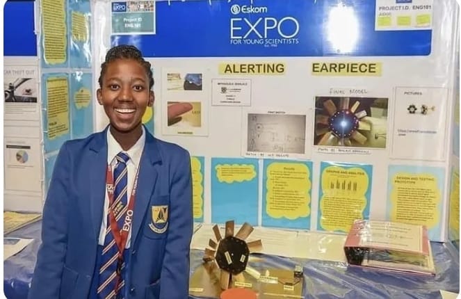 Bohlale Mphahlele smiling proudly in front of her science expo display featuring the Bohlale Mphahlele invention, a life-saving alerting earpiece for women and children.