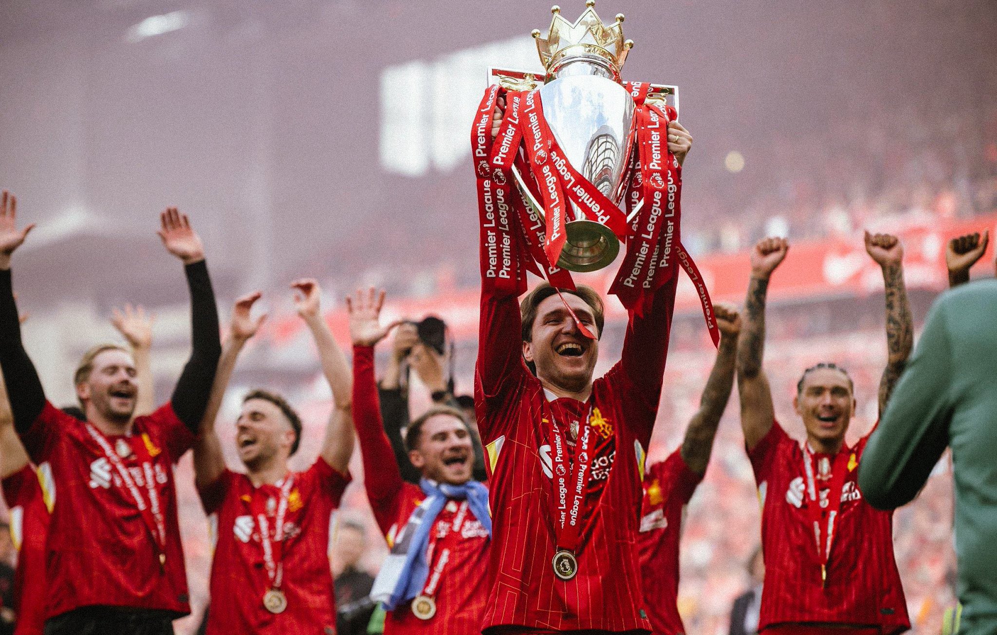 Liverpool striker, Federico Chiesa holding the EPL trophy
