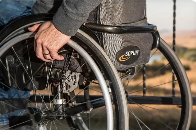 Injured Glencore employee picture illustration showing a close-up of a person using a wheelchair, symbolizing disability and resilience after a workplace injury.