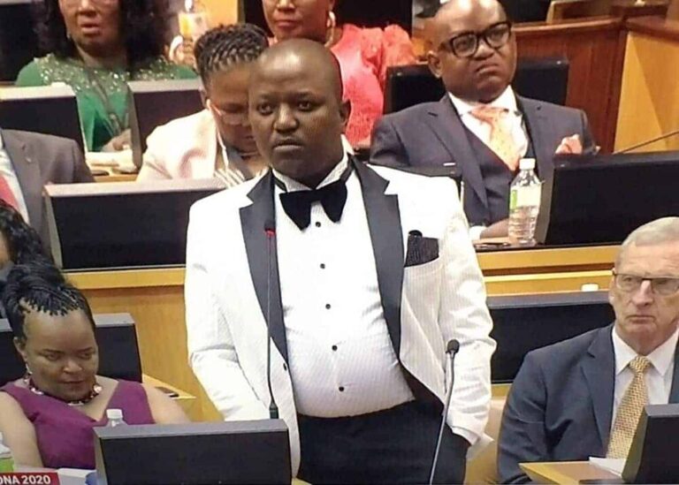 Boy Mamabolo Born To Win Party leader pictured in parliament wearing a white suit jacket with black lapels.