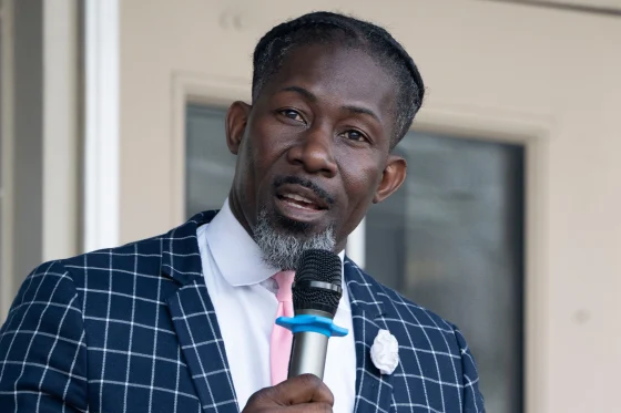 Ian Andre Roberts speaking at an event; his recent arrest has drawn public and official attention.