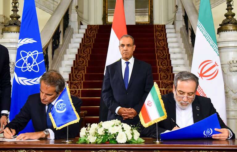 Iranian Foreign Minister Abbas Araghchi and IAEA Director General Rafael Grossi signing cooperation agreement