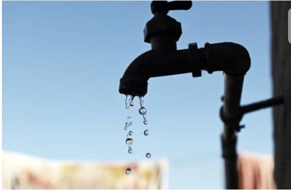 A close-up of a water tap dripping water against a clear blue sky, symbolizing water conservation during essential maintenance in Cape Town.