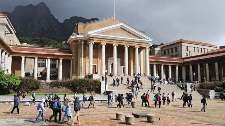 Sarah Baartman Hall renaming commemorated at the University of Cape Town campus with students walking past a historic building.