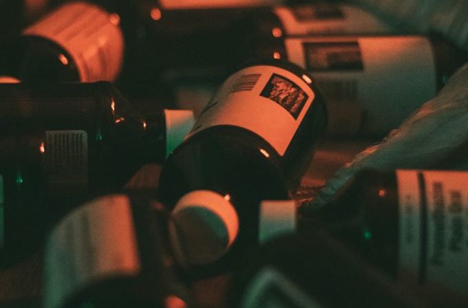Kids codeine crisis shown through scattered bottles of cough syrup on the ground.