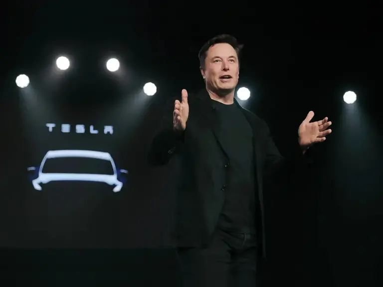 Elon Musk at Tesla event as Tesla stock disclosed a $1 billion stock purchase