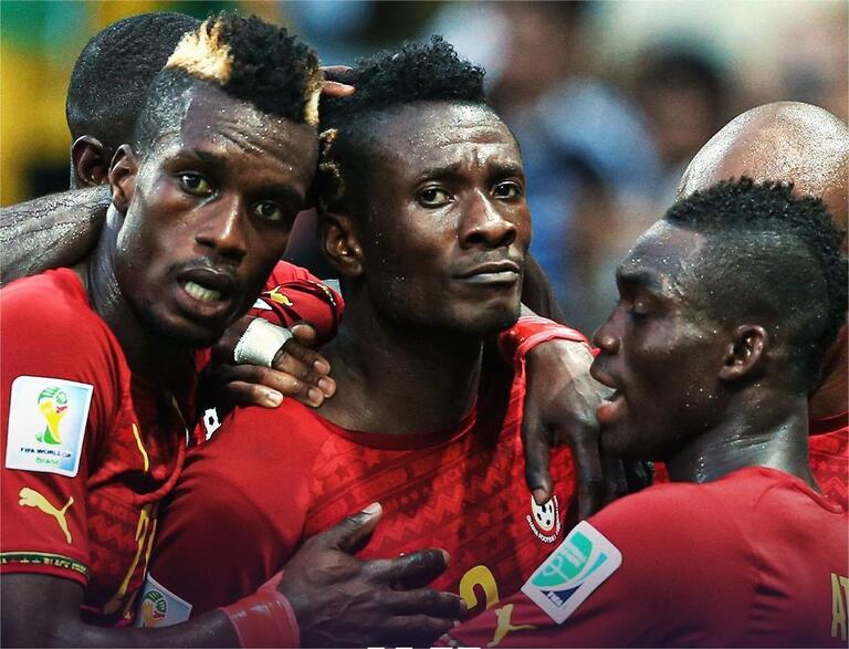 Gyan celebrating with his teammates.
