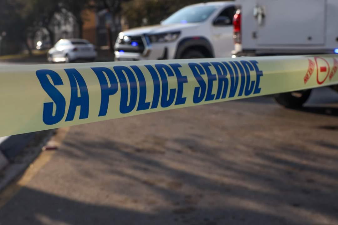 Police officers secure the crime scene after Pretoria shootout in Atteridgeville