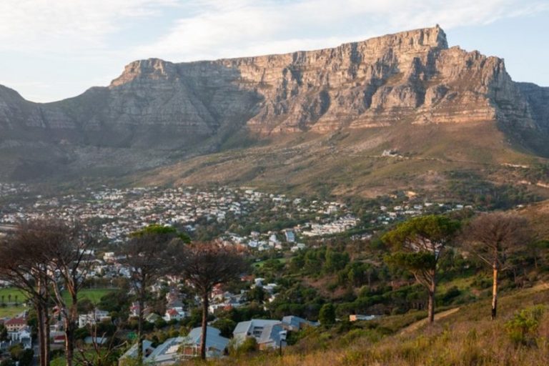 Cape Town's Tourism thrives with scenic views of Table Mountain towering over the city, showcasing the unique blend of natural beauty and urban life.