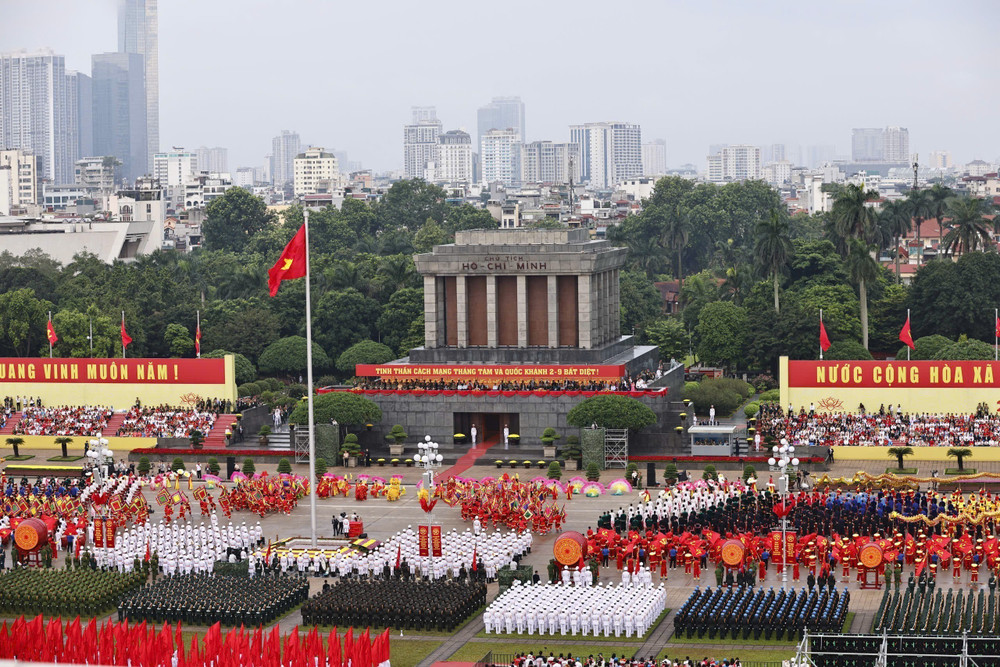 Vietnamese soldiers, tanks and helicopters parade in Hanoi on National Day, with crowds waving flags